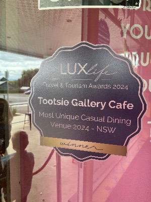 Front door signage. Opens the photo gallery.